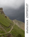 Path leading to storm clouds