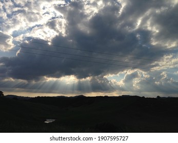 The Path Of Light Pouring Through The Thick Clouds Is The Scene