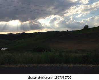 The Path Of Light Pouring Through The Thick Clouds Is The Scene