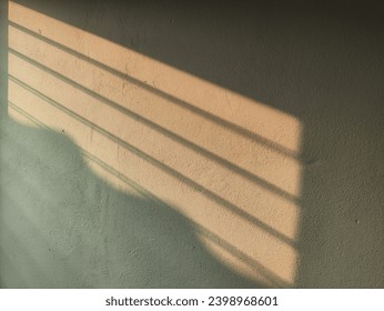 The path of light that shines through the window on the cement wall.  Patterns of afternoon light stream through the window.  Evening sunlight in the house. the classic of light. solar background.