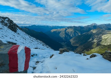 Path mark trail on rock on snow covered alpine meadow with panoramic view of mountain peaks in High Tauern National Park, Carinthia, Austria. Looking at majestic Boeseck. Wanderlust Austrian Alps - Powered by Shutterstock