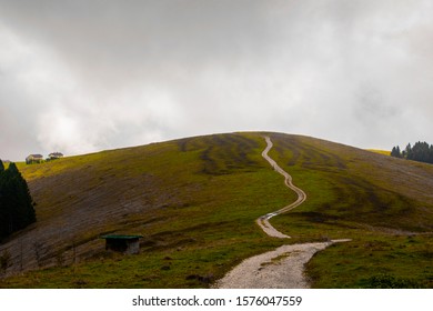 path meanders through the fields on the mountains of the Asiago plateau near Vicenza, Italy.
