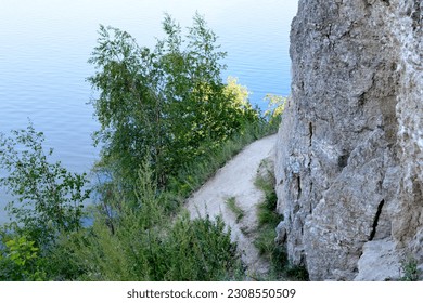 A path is in the mountains with the river on background   
