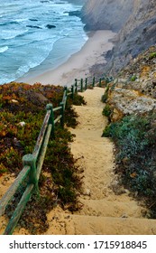 The path that goes down to the beach Praia de Lavagueira. Solo Backpacker Trekking on the Rota Vicentina and Fishermen's Trail in Alentejo, Portugal. Walking between cliff, ocean, nature and beach.