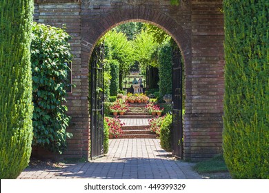 Path through an Arched Gateway to an English Walled Garden