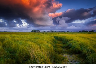 Path Through A Normandy Farm At Under A Dramatic Sunset