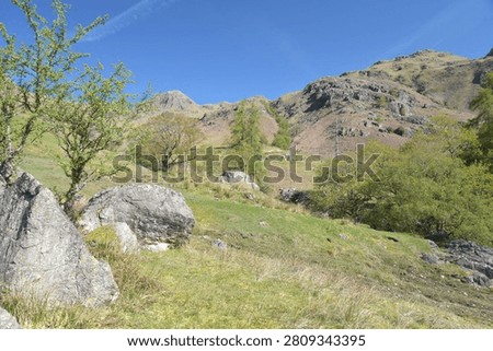A path through rocks and ravines beneath the Langdale Pikes in the Lake District