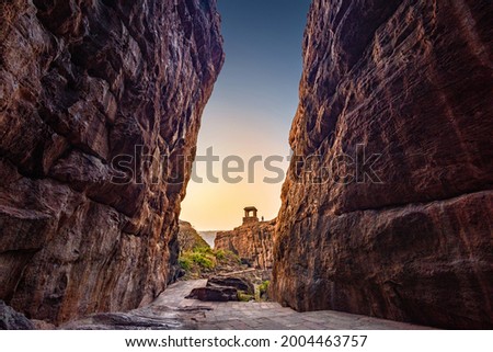 Path through steep cliffs, Entrance for lower and upper Shivalaya in Badami, Karnataka, INDIA. Passageway through rock cliffs.