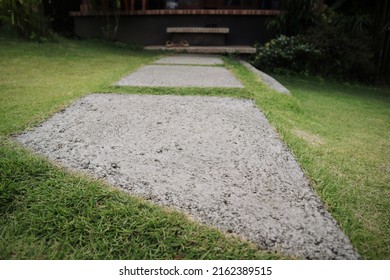 Path way made of concrete, was designed in the same size to each other and separated by green grass
