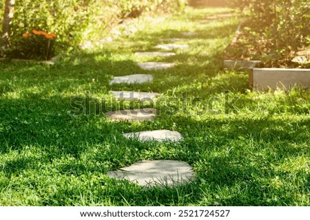 Path Way on Green Grass to Ecolife. Flat Stones Footpath in Landscape Design of Garden. Small Steps Go Green Eco Friendly Lifestyle concept. 