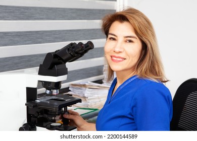 Pathologist Working With Stained Tissue Biopsy On Glass Slides In The Laboratory