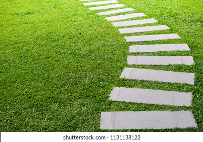 Pathway in the garden outdoor, forward stepping stones or pebbled in the grass lawn. Using for the roadway to success, achievement, leadership, milestone, vision, and mission concept. - Shutterstock ID 1131138122