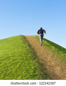 Pathway Up The Hill Against The Sky. Man Ran To The Top. Symbol Development Or Career Growth.