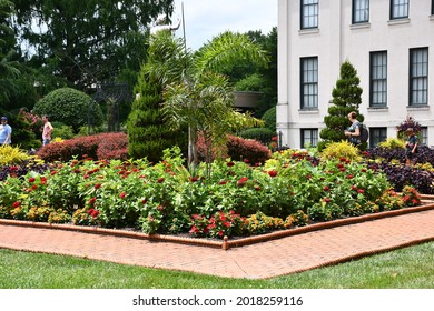 A Pathway At The Missouri Botanical Garden In St. Louis. People Are Walking. There Are Bushes With Red Flowers. Picture Taken On July 19th, 2021.