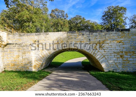 Pathway passing under one of the arches of the old collapsed medieval bridge of Vernon, Normandy, France
