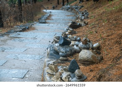 pathway with pebble stack at the Buddhist temple in the rain