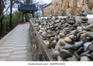 pathway with pebble stack at the Buddhist temple in the rain