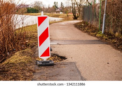 Pathway Pot Hole With A Warning Sign 