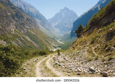 Pathway and winding river in the valley between the mountains