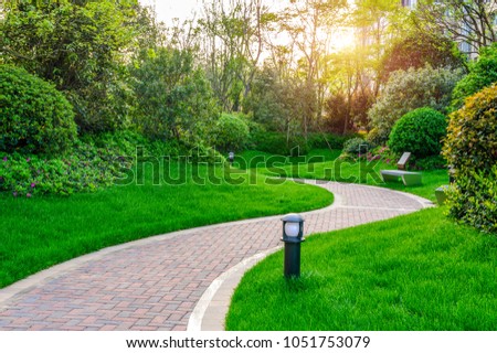 Pathways with green lawns, Landscaping in the garden,Top view of curve walkway on green grass field and flower garden 