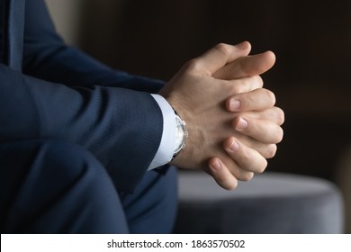Patience And Concentration. Close Up View Of Young Businessman In Classic Suit Sitting With Hands Clasped Keeping Fingers In Lock Waiting Expecting Preparing For Job Interview Meeting Negotiations