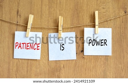 Patience is power symbol. Concept words Patience is power on beautiful white paper on clothespin. Beautiful wooden table wooden background. Business and patience is power concept. Copy space.