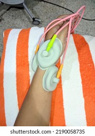 Patient applying electrical stimulation therapy on wirst joint. Electric therapy tens. - Shutterstock ID 2190058735