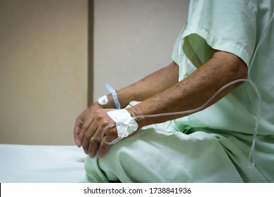 Patient Asian Elder Man 70s With Saline Intravenous At C-line Or A-line On A Elderly Patient Hand On Patient Bed In Intensive Care Unit (ICU.) Room At Hospital.