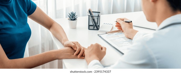 Patient attend doctor's appointment at clinic or hospital office, discussing medical treatment option and explaining diagnostic result while consoling and comforting patient. Panorama Rigid - Shutterstock ID 2395174337