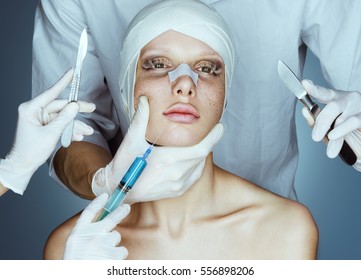 Patient in bandages. Nurses holding scalpel and syringe near her face. Plastic Surgery concept