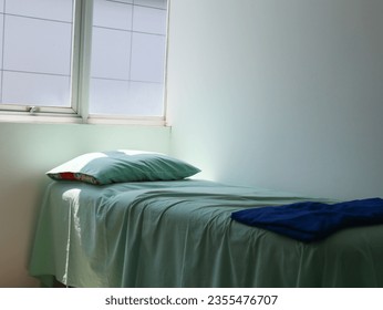patient bed in the clinic with green sheet and blue blanket - Powered by Shutterstock
