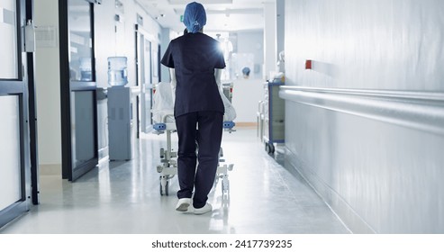 Patient, bed and nurse walking in hospital, hallway or corridor to surgery, operation room or ER healthcare service. Doctor, moving and pushing person in clinic to ICU, bedroom or walk backward - Powered by Shutterstock