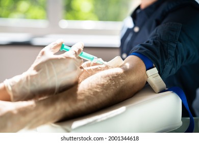 Patient Blood Draw By Doctor. People Donate And Test