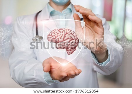 Patient brain treatment and protection concept. The doctor shows the brain protected by the shield.