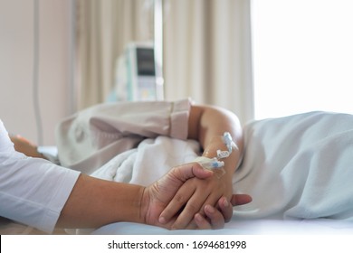 Patient care concept : hope comforting sick of Hopeful love care emotional Couple women hold hands lover that sick lying in Hospital bed with love emotional, Recovering from family healthy