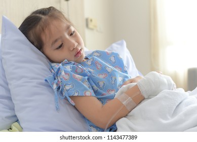 Patient Child Laying On Hospital Bed With Saline Solution Intravenous