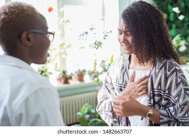 The Patient Complains To The Doctor About Heart Pain. Heart Attack And Cardiovascular Disease Care Concept. Mixed Race Young People