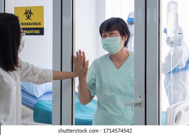 Patient With Coronavirus Infection In Negative Pressure Quarantine Room With Quarantine Alert Sign At Hospital Feel Happy And Cheerful With Family Member. Coronavirus, Covid19 And Medical Concept.