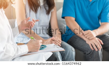 Patient couple consulting with doctor or psychologist on marriage counseling, family medical healthcare therapy, In vitro fertility IVF treatment for infertility, or psychotherapy session concept
