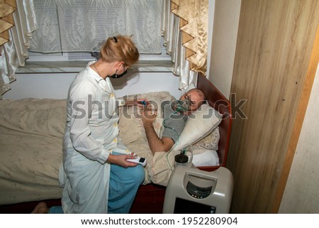 Similar – Caregiver making bed of elderly patient in nursing home