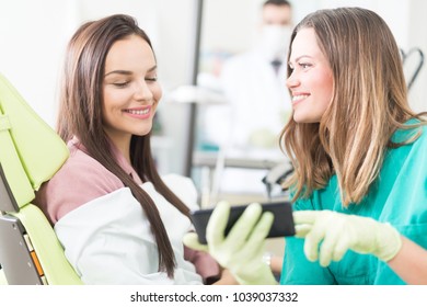 Patient and dentist faving fun in dentist office - Shutterstock ID 1039037332