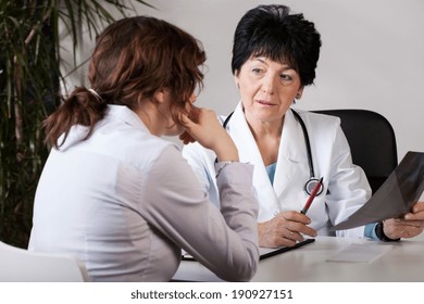 A Patient And A Doctor Analyzing The Outcome Of An Examination