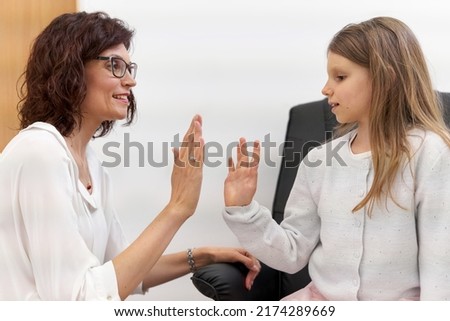 Patient and doctor high five in a clinic after a biofeedback session
