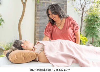 Patient in an energy therapy, lying on a stretcher in the garden - Powered by Shutterstock