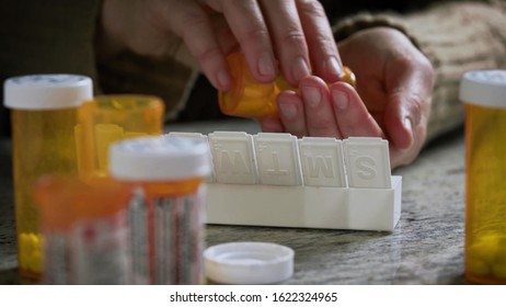 Patient Is Filling Weekly Pills In His Tablet Organizer.