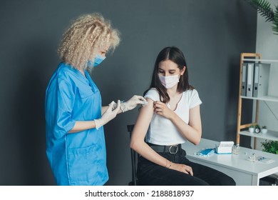 Patient Getting Vaccinated With Covid Vaccine Intramuscular Injection During Doctor's Appointment In Hospital. Vaccine, Human Clinical Trial And Vaccination