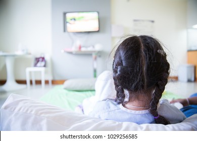 Patient girl watching television in hospital