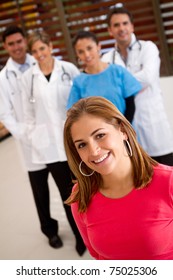 Patient With A Group Of Doctors At The Background