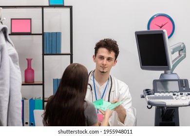 A Patient Hands The Doctor A Folder With All The Test Results. Primary Care Physician. Doctor's Office