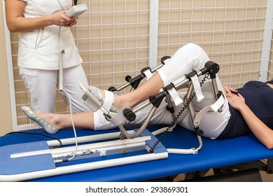 Patient Having Knee Rehabilitation In Medical Office